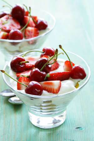 Dairy yogurt dessert with cherries and strawberriesの写真素材