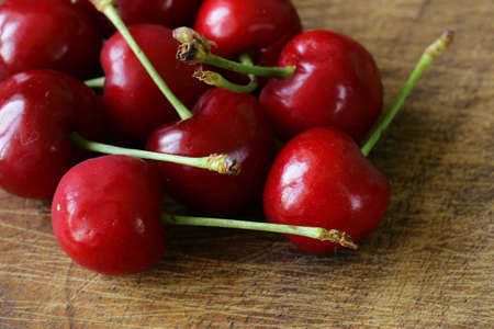 fresh red ripe cherries on a wooden tableの写真素材