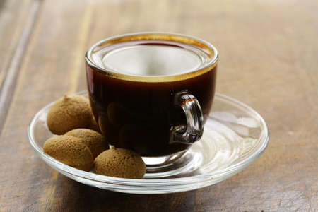 cup of black coffee with biscuits amaretti  almond cookies の写真素材
