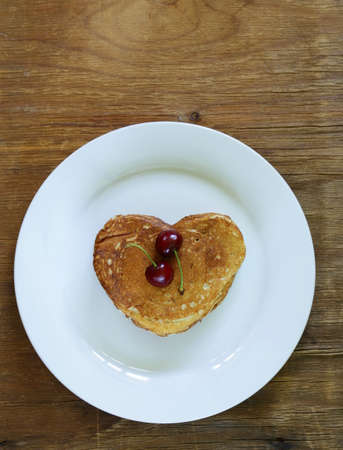 sweet dessert pancakes in the shape of a heart for breakfastの写真素材