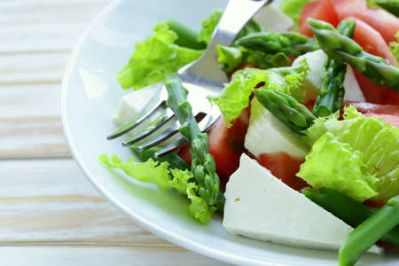 fresh salad with tomatoes, asparagus and cheeseの写真素材