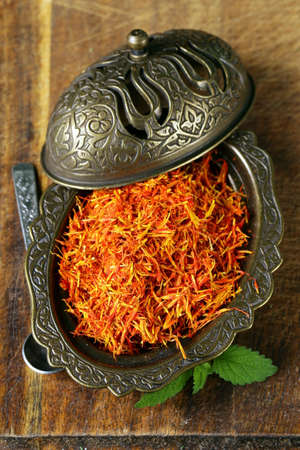 Saffron spice in metal bowl macro shot soft focusの写真素材