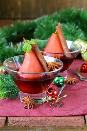 pears cooked in wine with spices  cinnamon and anise  Christmas table settingの写真素材