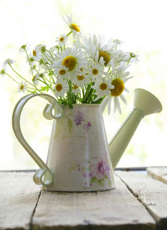 bouquet of fresh daisies camomile on a wooden backgroundの写真素材