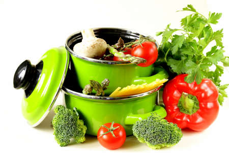 green pots full of vegetables  tomatoes, asparagus, mushrooms, broccoli  and pastaの写真素材