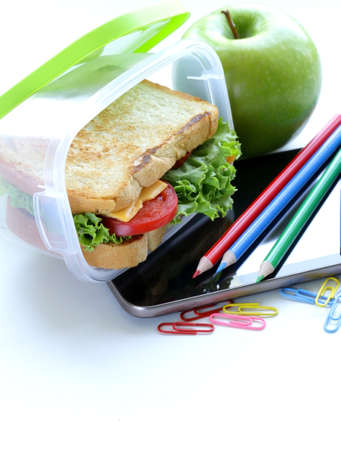 sandwich with cheese and tomato and green apple for a healthy school lunchの写真素材