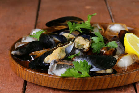 fresh delicious seafood mussels with green parsleyの写真素材