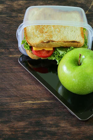 sandwich with cheese and tomato and green apple for a healthy  lunchの写真素材