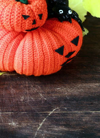 Halloween still life - pumpkin with  yellow leaves on the wooden backgroundの写真素材