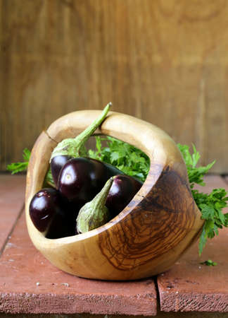 fresh ripe vegetables purple eggplant  on a wooden tableの写真素材