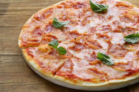 traditional Italian pizza with prosciutto ham and basilの写真素材
