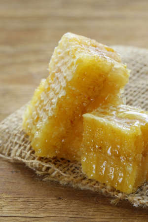 natural organic honey in the comb on a wooden background