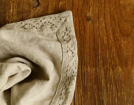 old wooden background with gray linen lace napkinの写真素材