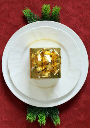 Christmas table setting (white plates on a red background)