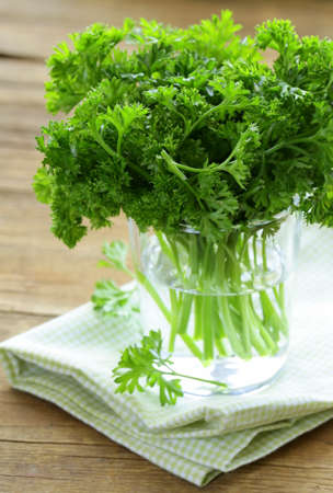 fresh green organic parsley on a wooden tableの写真素材