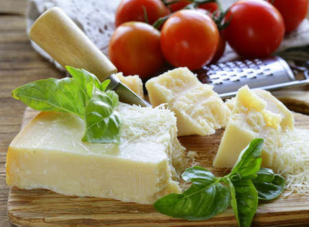 fresh tasty hard parmesan cheese on a wooden boardの写真素材