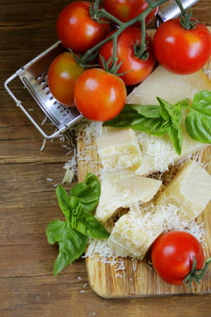 fresh tasty hard parmesan cheese on a wooden boardの写真素材