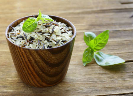 mix of wild black and white rice in a wooden bowlの写真素材