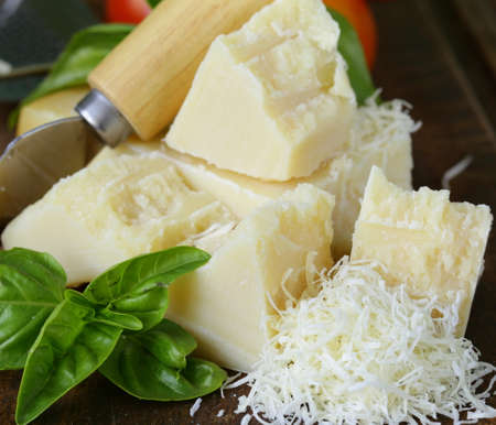 fresh tasty hard parmesan cheese on a wooden board