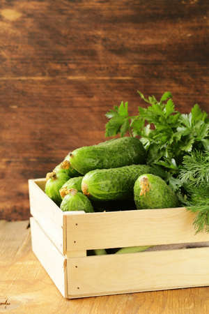fresh organic cucumbers in a wooden boxの写真素材