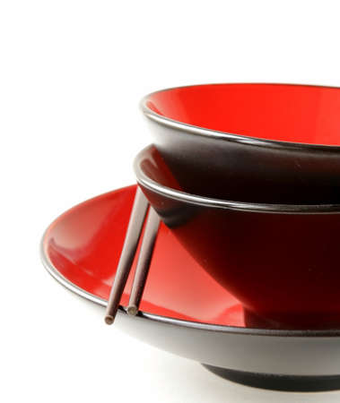 Red asian style tableware bowls with chopsticksの写真素材