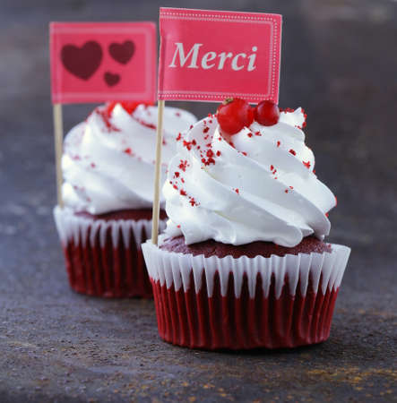 festive red velvet cupcakes with a gift compliment cardの写真素材
