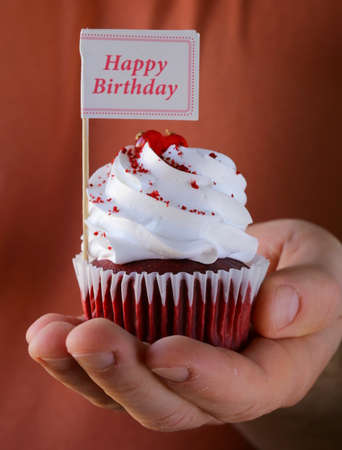 festive red velvet cupcakes with a gift compliment cardの写真素材
