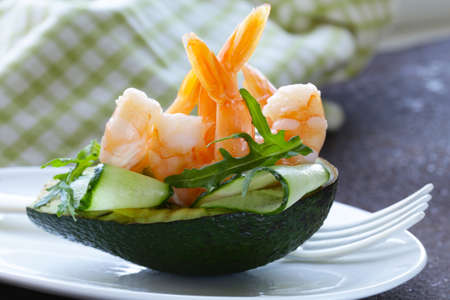 Fresh avocado with shrimp and cucumber served on a plateの写真素材