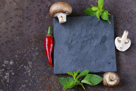 Food background on slate with herbs and vegetablesの写真素材
