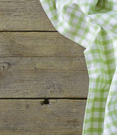 Wooden background with green checkered kitchen towelの写真素材