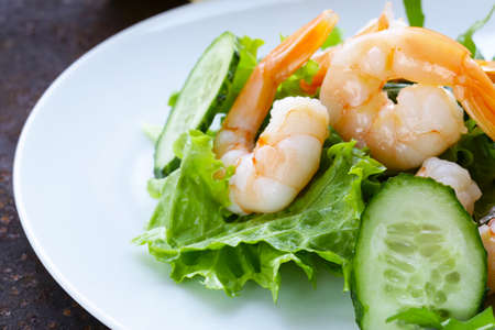 green salad with fresh cucumbers and shrimpsの写真素材