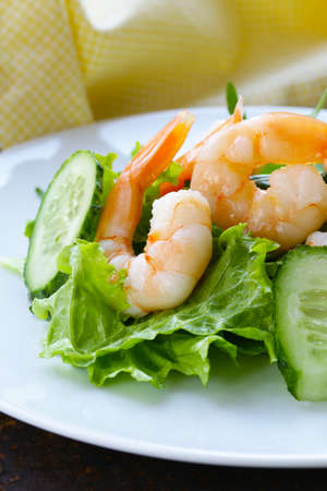 green salad with fresh cucumbers and shrimpsの写真素材