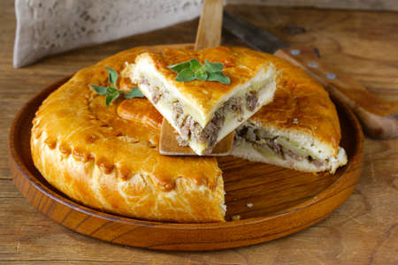 homemade meat pie with potatoes and oregano