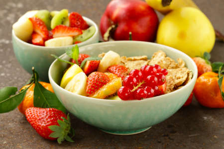 homemade granola muesli with fruit salad for breakfastの写真素材