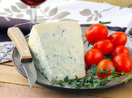 piece of blue cheese with fruits and herbsの写真素材