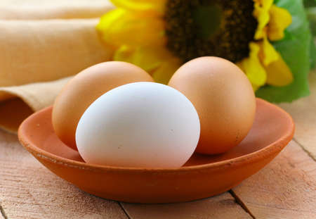 natural organic eggs in the clay dish, rustic styleの写真素材