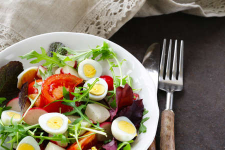 Easter Spring salad with quail eggs, tomatoes and cucumbersの写真素材