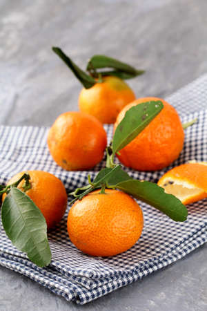 ripe organic fruit tangerines with green leaves