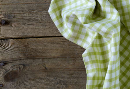 Wooden background with checkered kitchen towelの写真素材