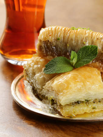 Turkish arabic dessert - baklava with honey and walnut, pistachios nutsの写真素材