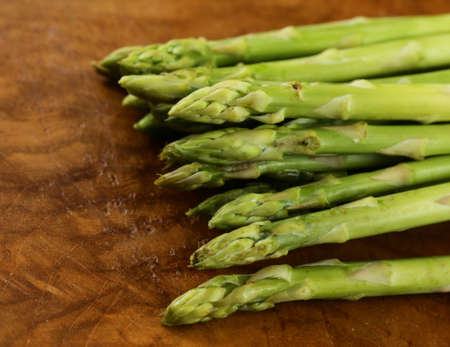 fresh green asparagus - spring vegetable on a wooden backgroundの写真素材