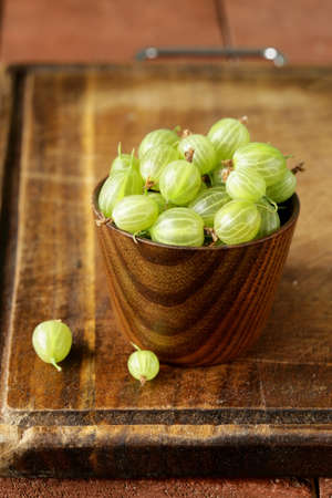 berries green gooseberries in a glass on the tableの写真素材