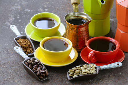 green black coffee beans and different utensils for boiling coffee grinder kettle cezve