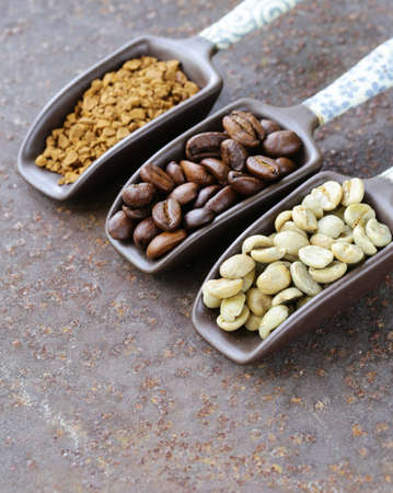 Green black coffee beans and ground in the scoopの写真素材