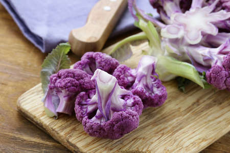 purple broccoli on a wooden table rustic still lifeの写真素材