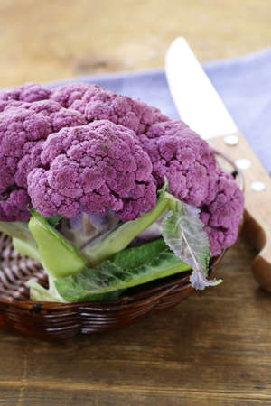 purple broccoli on a wooden table rustic still lifeの写真素材