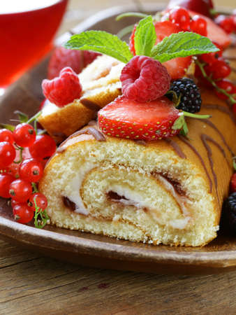 biscuit roulade with butter cream and fresh berriesの写真素材