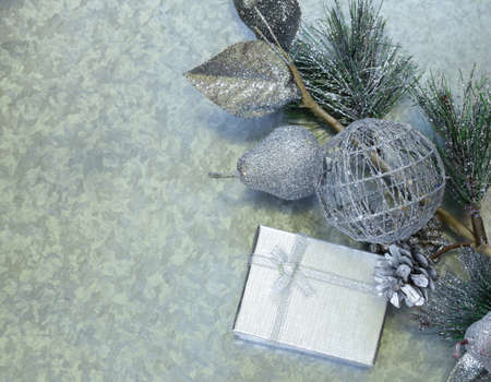 Christmas background fir branches with silver decorations and gift boxの写真素材