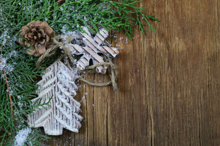 fir branches arborvitae with wooden Christmas decorationsの写真素材