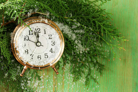 Christmas composition with fir branches, decorations and old clock